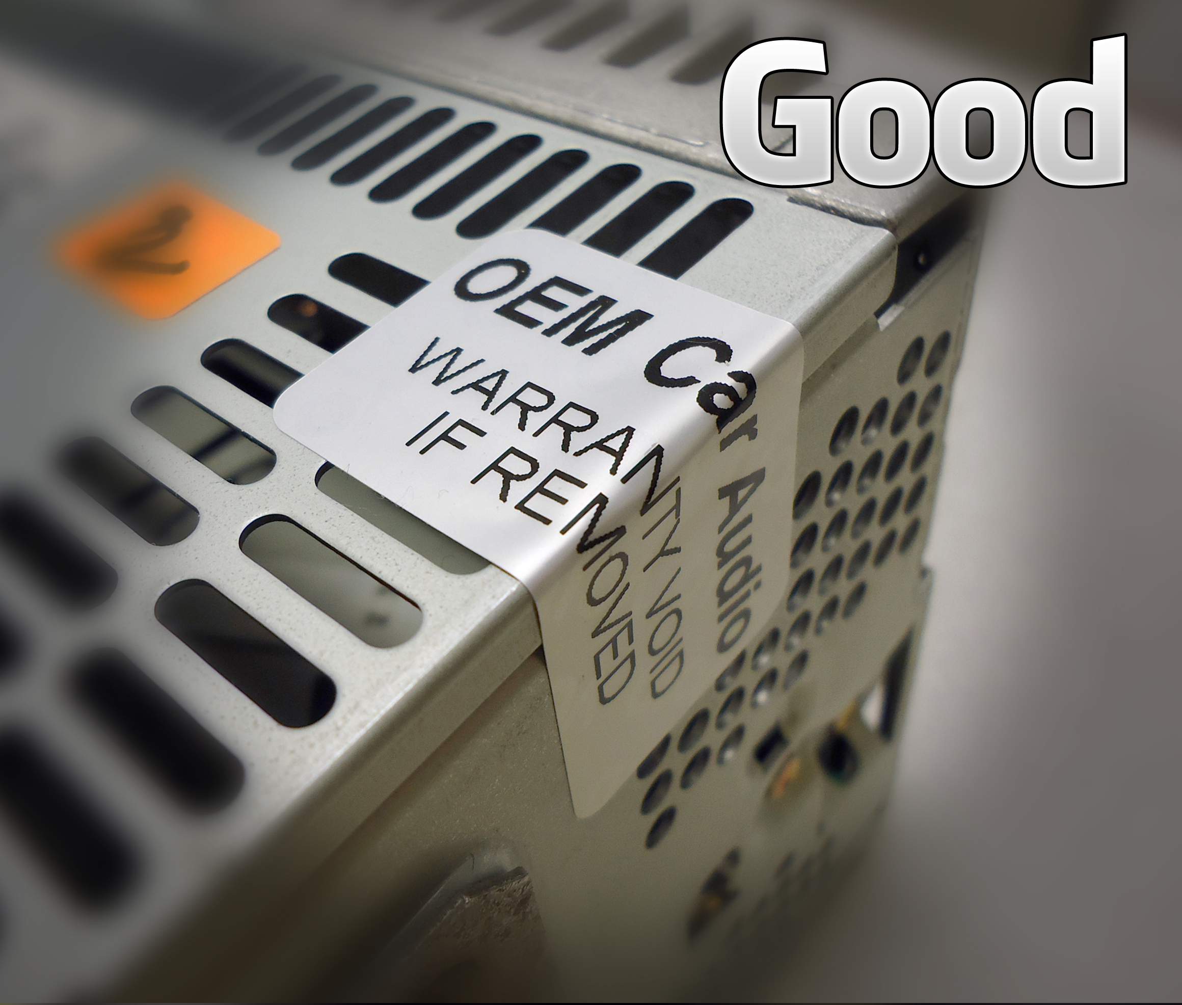 An intact Original Car Audio warranty sticker wrapped across the edge of a radio's metal case